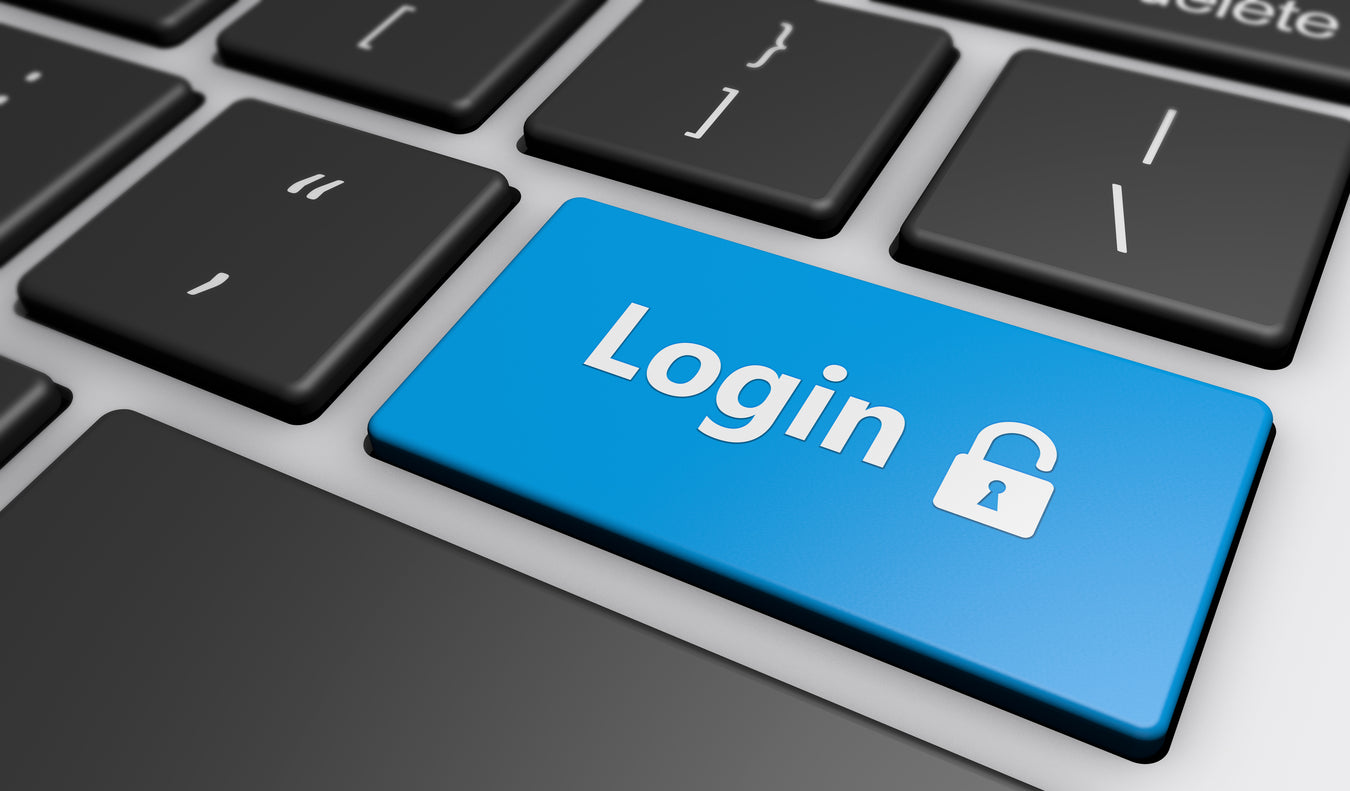 Das Bild zeigt einen blauen Login Button auf einer Tastatur. 